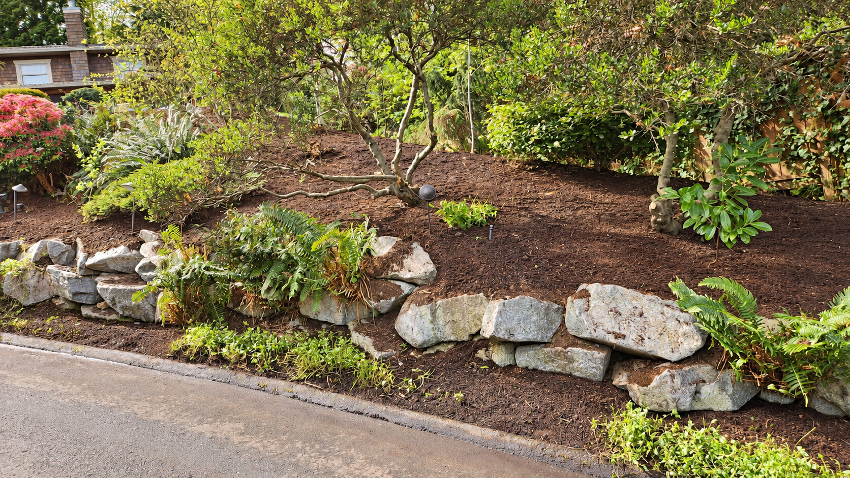 Garden bed with rock border and fresh mulch